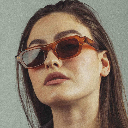 A woman wearing retro small square frames and simple sunglasses